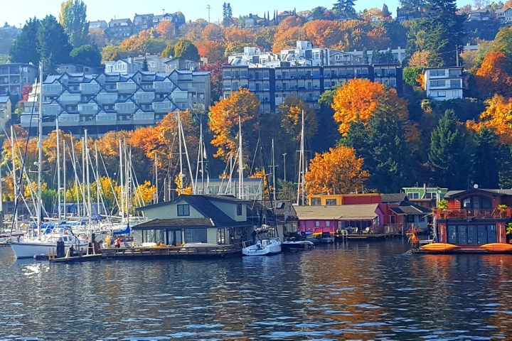 a small boat in a body of water with a city in the background