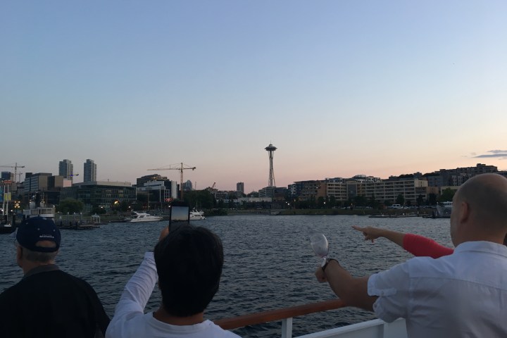 a group of people standing next to a body of water