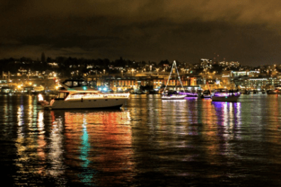 a small boat in a harbor next to a body of water