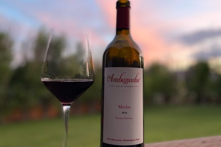 a close up of a bottle and a glass of wine