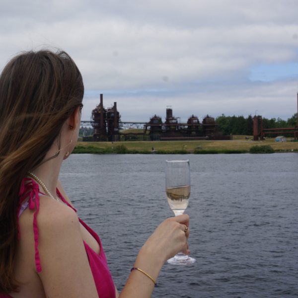 a person drinking out of a body of water