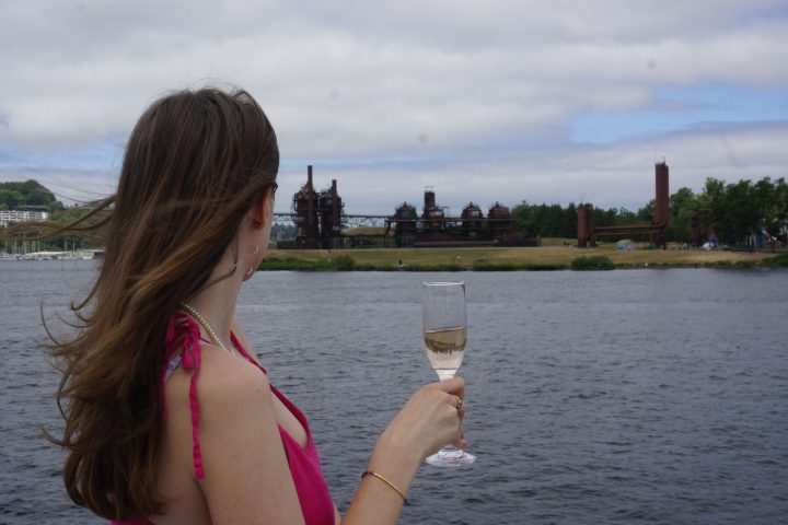 a person drinking out of a body of water