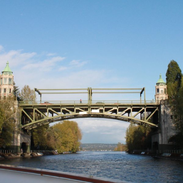 a train crossing a bridge over a body of water