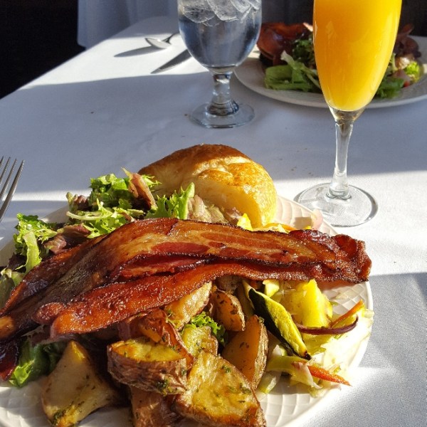 a plate of food and a glass of orange juice