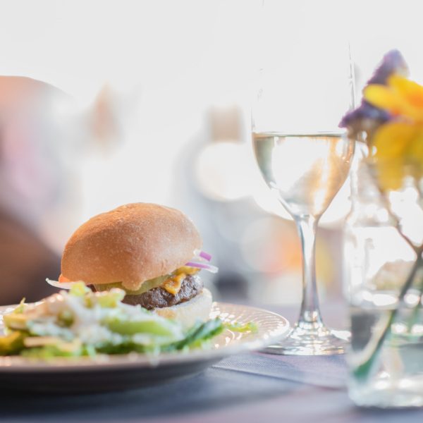 a close up of a plate of food and glasses of wine