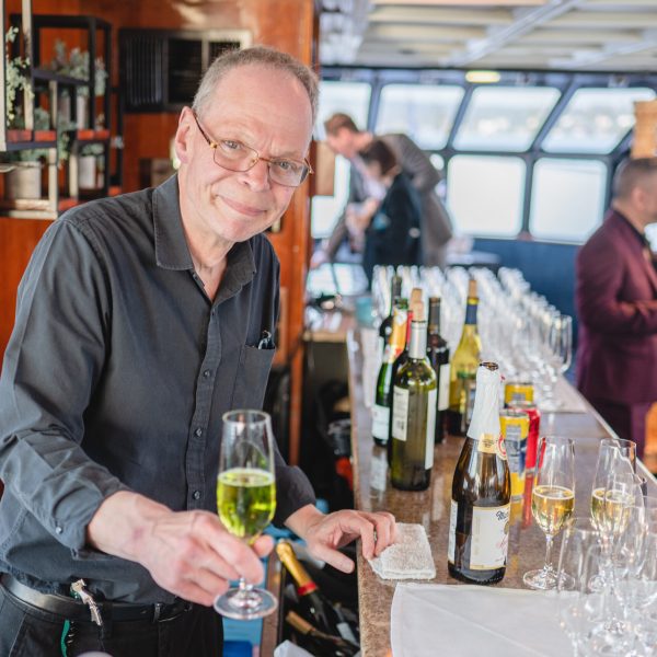 a group of people sitting at a table with wine glasses