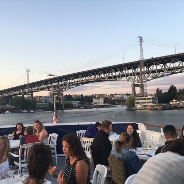 a group of people crossing a bridge over a body of water