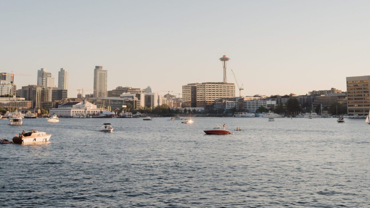 a small boat in a body of water with a city in the background