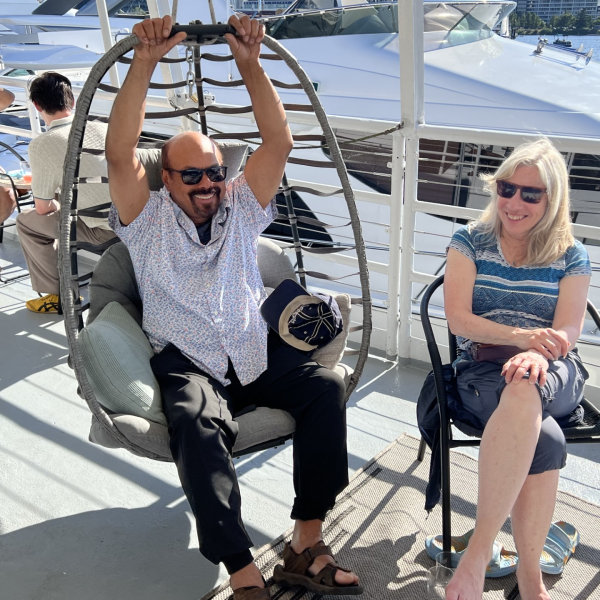 a group of people sitting at a dock