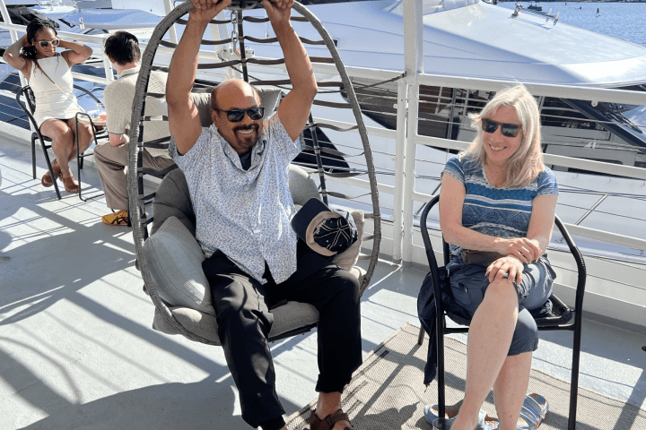 a group of people sitting at a dock