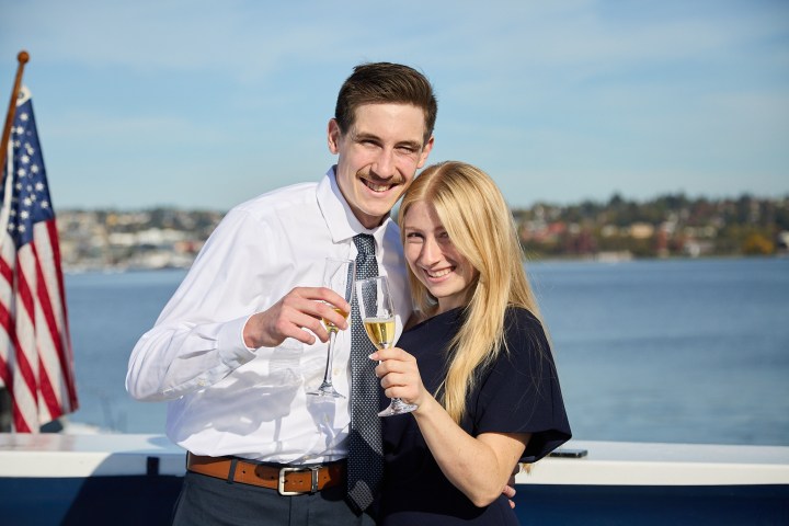a man standing next to a body of water