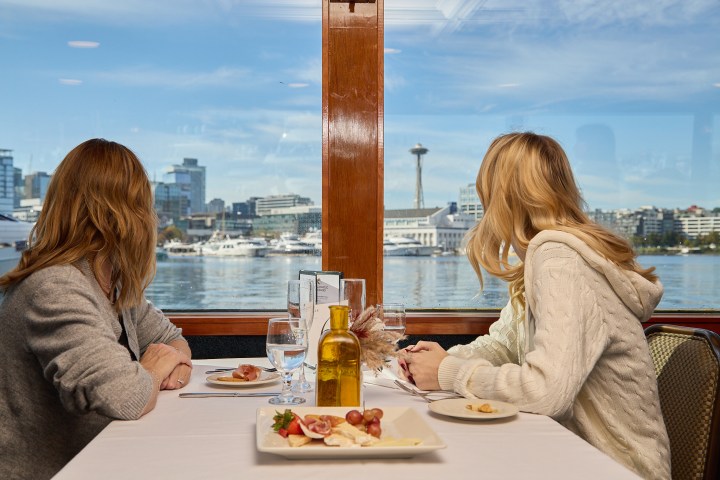 a woman sitting at a table eating food