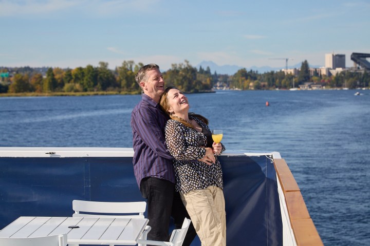 a person standing next to a body of water