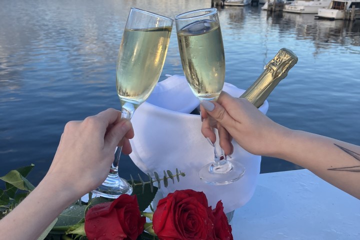 a woman drinking water from a boat